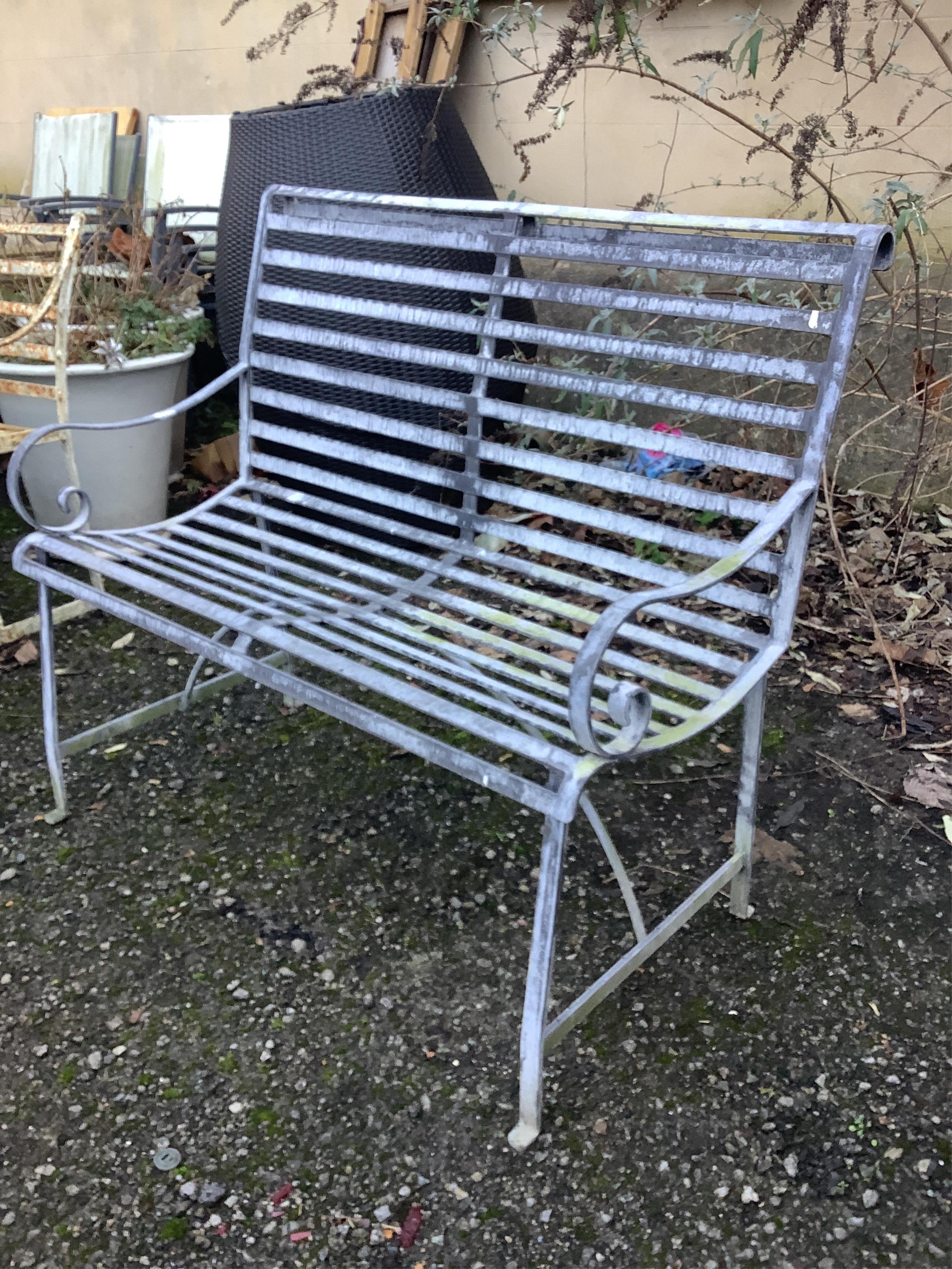 A 19th century style slatted wrought iron garden bench, width 107cm, depth 42cm, height 94cm. Condition - fair to good